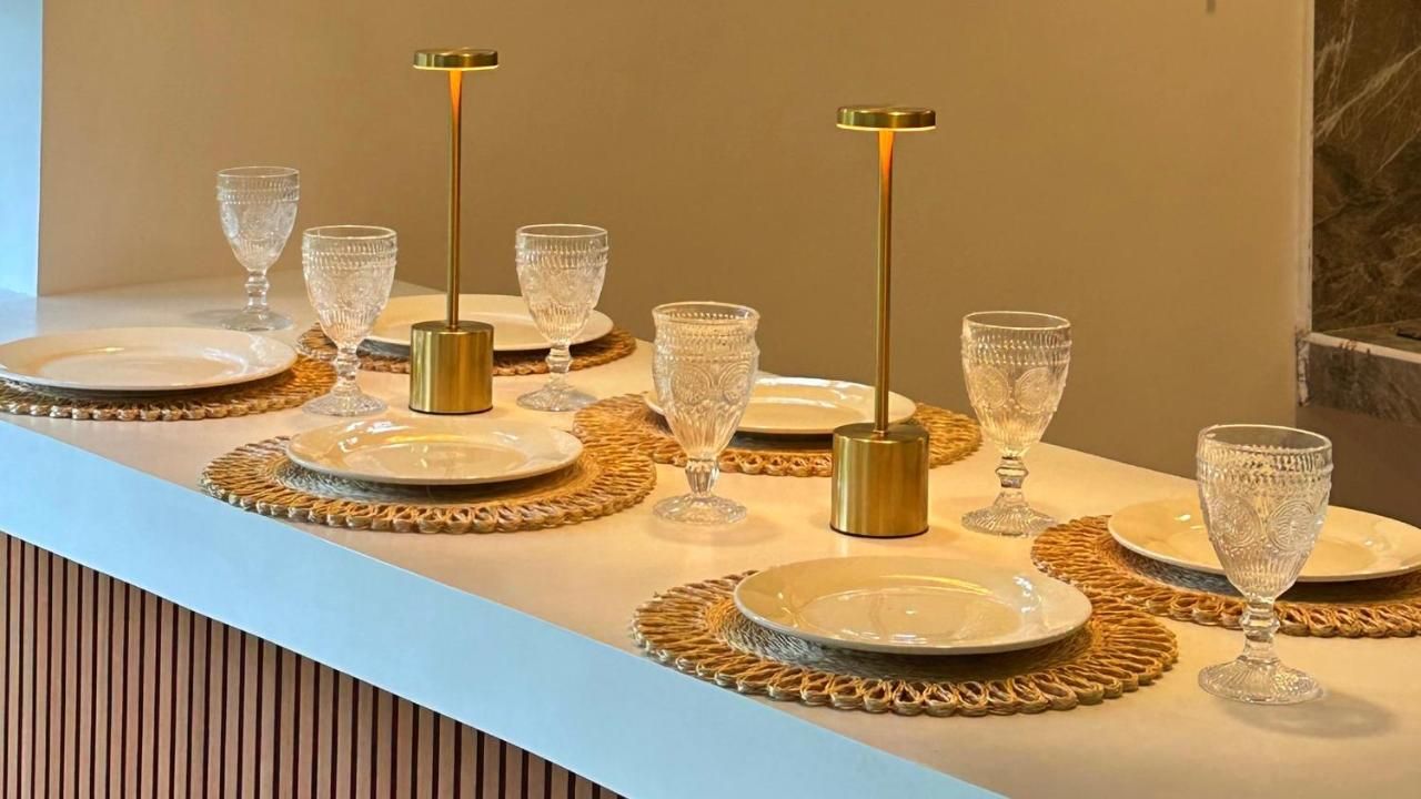 Bar counter set with plates, glasses and brass table lamps