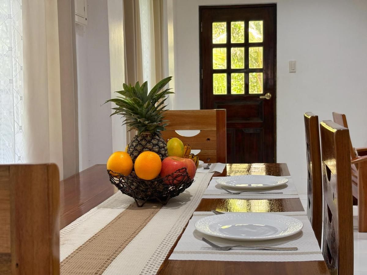 Dining table with a fruit bowl and place settings